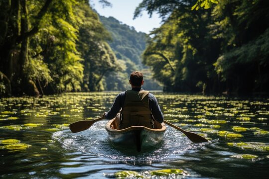 Person kayaking through a calm river - stock photography concepts