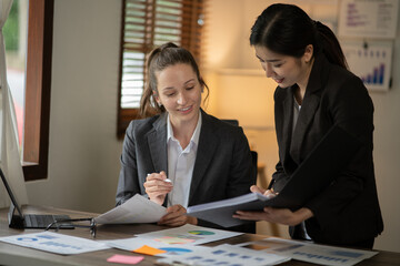 Asian businessmen, women and men Talk about new projects, presents at home office.