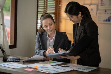 Asian businessmen, women and men Talk about new projects, presents at home office.
