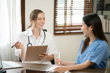 female doctor consulting with a female nurse at the clinic at the hospital