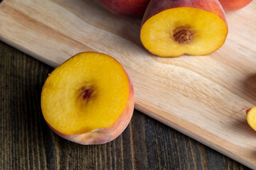 Naklejka na ściany i meble Ripe fresh peaches on a wooden table