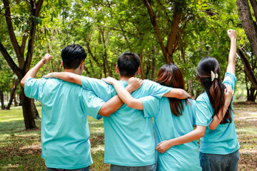 Asian youth volunteer group Hugging, raising arms, gathering power to do good deeds. Volunteer...