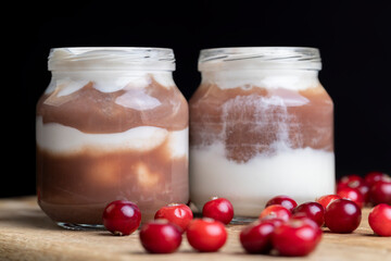 Yogurt with plum jam in a jar