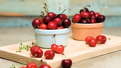 Red ripe cherries in ceramic bowls