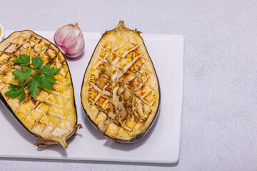 Grilled eggplants with olive oil, garlic and greens. Traditional food for picnic or barbecue