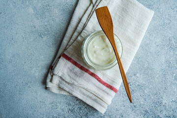 Overhead view of a glass jar with traditional fermented yogurt (matsoni)