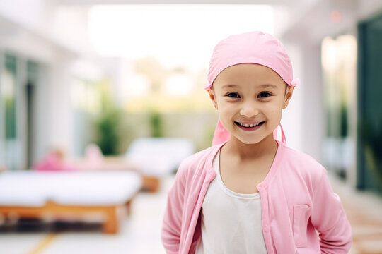 Happy cancer patient. Smiling girl after chemotherapy treatment at hospital oncology department. Leukemia cancer recovery. Cancer survivor. Portrait smiling bald cute girl with a pink headscarf.