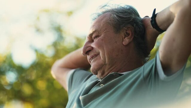 Senior man relaxing outdoors enjoying retirement. A happy mature 70s male person in thoughtful expression in nature