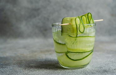 Glass of cucumber water or a cucumber cocktail on a table
