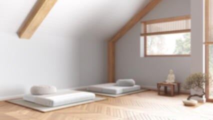 Blurred background, minimal meditation room in modern penthouse. Pillows, tatami mats and window. Wooden beams and parquet floor. Japanese interior design
