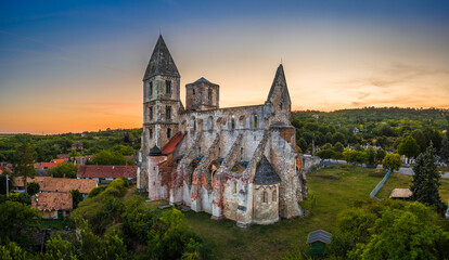 Zsambek, Hungary - Aerial panoramic view of the beautiful Premontre Monastery ruin church of Zsambek (Schambeck) with colorful dramatic sunset at background at summertime