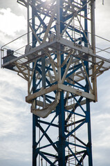 Large metal construction crane against the sky