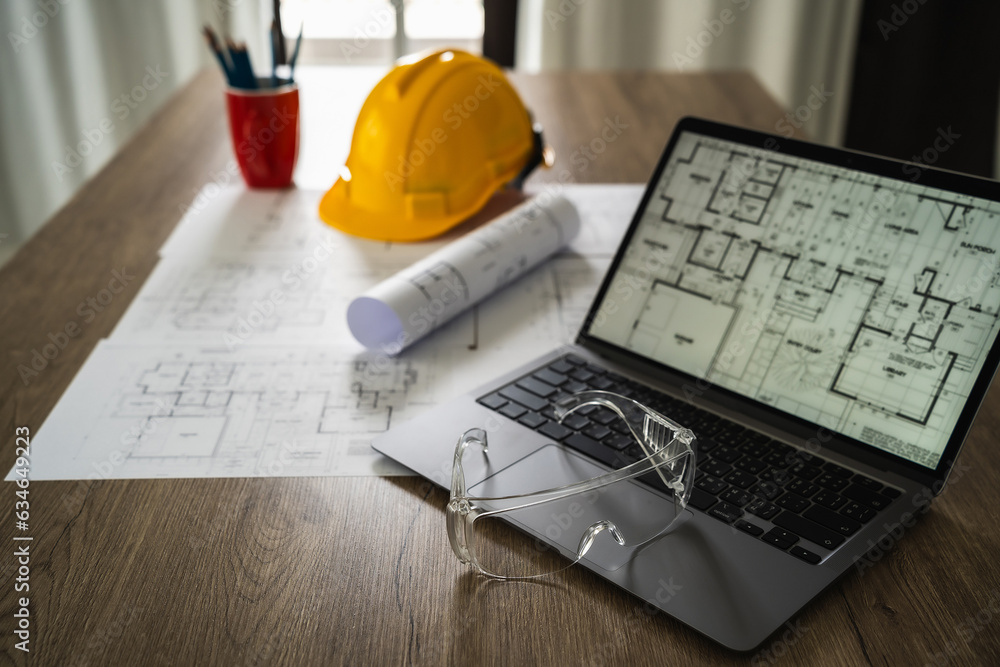 Poster architecture plans architect paper clear protective glasses on a notebook computer discussing buildi