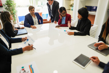 Multigenerational colleagues working inside business office - Entrepreneurs people sharing ideas at teamwork meeting - Brainstorming and inclusion concept - Main focus on african woman face
