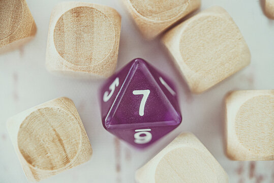 Close-up of an 8 sided dice amongst blank wooden cubes