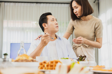 Asian wife talk with husband in breakfast, Happy family talking before going out to work