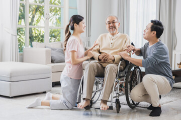 happy Asian family, senior man on wheelchair with daughter and son at home