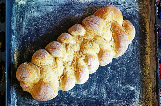 Overhead view of a Hefezopf (braided sweet bread) on a baking tray