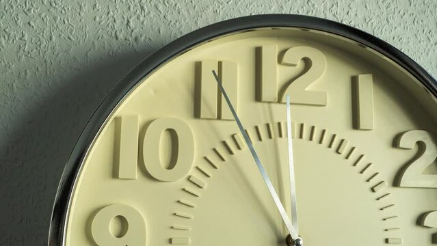 Timelapse Large wall clock on a gray wall. Wall clock movement by camera.