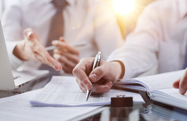 man making notes during business meeting in an office