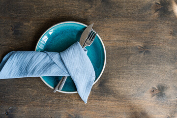 Overhead view of a blue place setting on a table