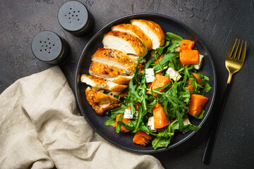 Chicken salad with pumpkin and arugula. Dash diet, keto diet meal. Top view image.