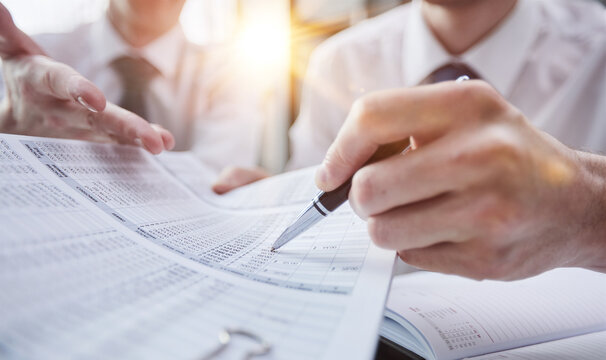Hand makes notes on a paper notebook, close-up