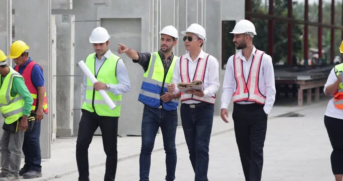 Ethnic diversity worker people. Success teamwork. Group of professional Construction engineering people wearing hardhat safety helmet meeting at Prefabricated concrete walls Industry 