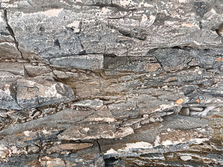 Wet Stone Sea Coast Background Texture. A Grungy and Weathered Abstract Texture of Gray Stones on the Coastline