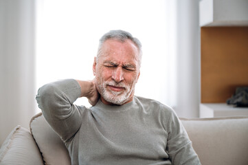 middle aged man feeling discomfort and neck ache