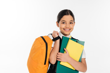 happy schoolgirl standing with notebooks in and backpack in hands, new school year concept, student