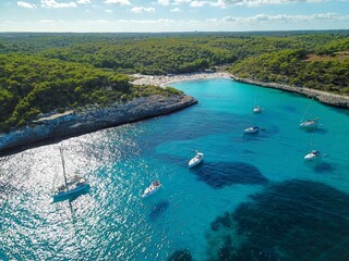 Aerial view of floating boats in Cala Llombards