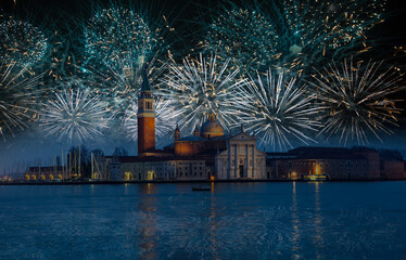  View of San Giorgio Island in Venice with wooden buoys in Giudecca Canal with fireworks