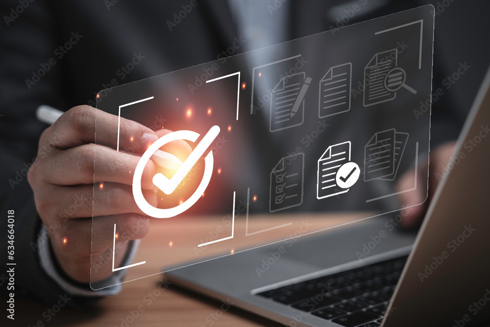 Poster Businessman using laptop computer with correct sign mark and document icon for ISO or International Standard Organisation which related quality control and continuous improvement concept.