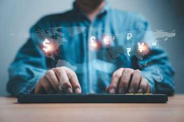 Businessman typing computer keyboard with virtual map and international currency include dollar Yuan Euro pound sterling ruble for forex trading and money transfer concept.
