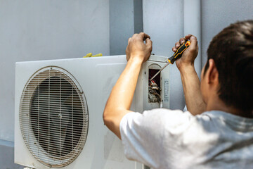 The electrician repairing the air conditioner, Technician is checking the coolness air compressor