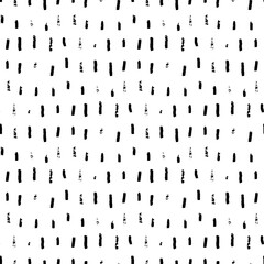 Rough seamless pattern with brush stripes and thin strokes. Black vertical doodle dashes on white background. Hand painted grunge texture. Dry smears and short brushstrokes. Modern vector background