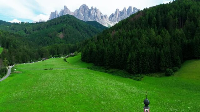 Church of St. Johann with The Dolomites mountains in the background in Val Di Funes valley, Trentino Alto Adige region, Italy, Europe.