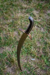 Yakushyntsi, Ukraine - 24.07.2021: traditional sabre of Zaporozhian Sich kozak, effective and light cold cavalry and infantry weapon with curved blade at Living Fire Midsummer Pagan Ethno festival - obrazy, fototapety, plakaty