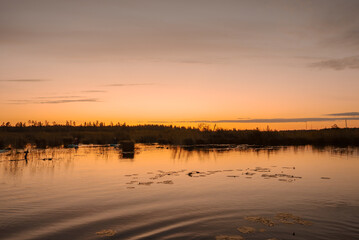 Magical sunrise over the lake. Early summer morning. 