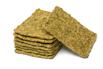 Heap of vegetable crackers seasoned with spinach isolated on white background