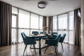 Dining room with wooden table and blue chairs floor in modern apartment