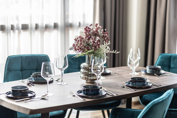 Dining room with wooden table and blue chairs floor in modern apartment