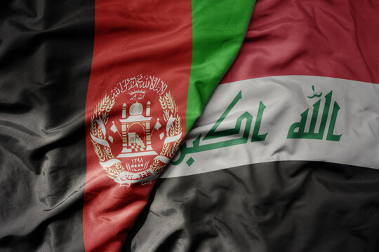 big waving realistic national colorful flag of afghanistan and national flag of iraq .