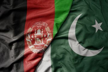 big waving realistic national colorful flag of afghanistan and national flag of pakistan .