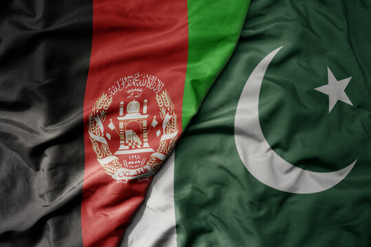 big waving realistic national colorful flag of afghanistan and national flag of pakistan .