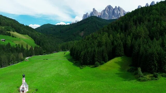 Church of St. Johann with The Dolomites mountains in the background in Val Di Funes valley, Trentino Alto Adige region, Italy, Europe.
