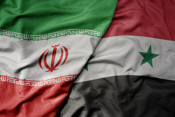 big waving realistic national colorful flag of iran and national flag of syria .