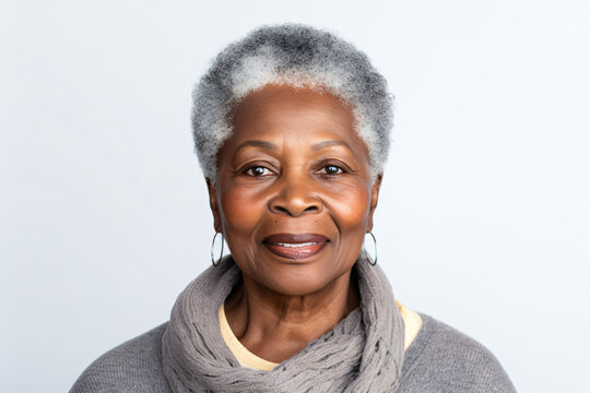 Close-up portrait of an elderly African American woman with gray hair, studio shot, isolated on white background.
Generative AI.