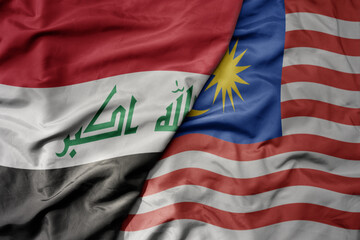 big waving realistic national colorful flag of iraq and national flag of malaysia .